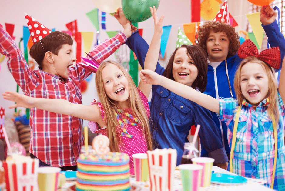 A group of kids celebrating - Fun & Inexpensive Theme Ideas for Kids' Birthday Parties