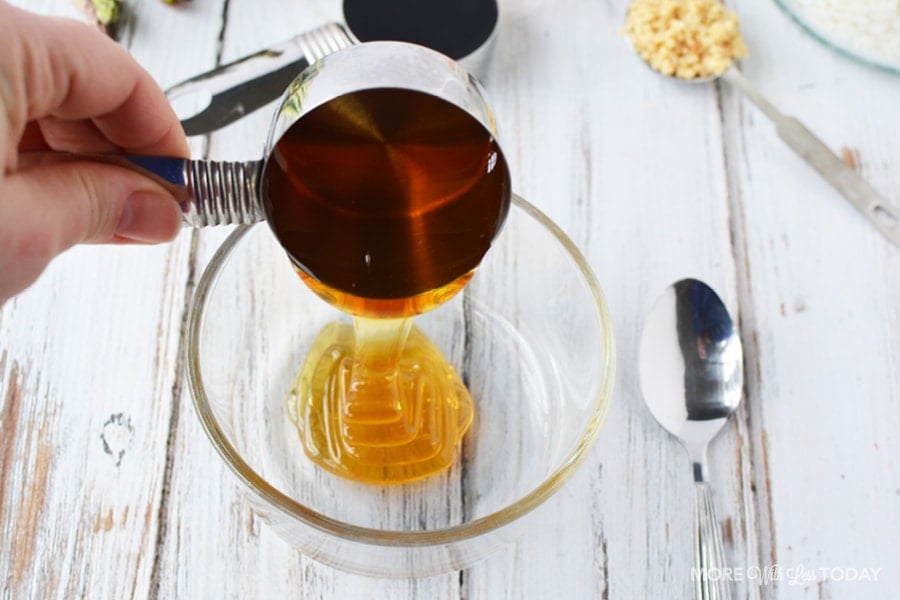 Adding honey to a clear bowl