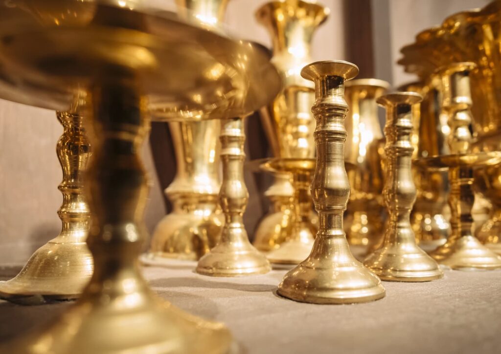 a grouping of brass candlesticks genius uses for table salt