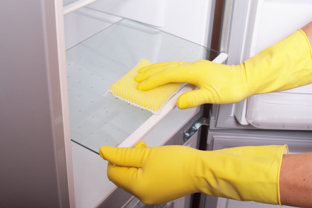 photo of rubber gloves cleaning a dishwasher
