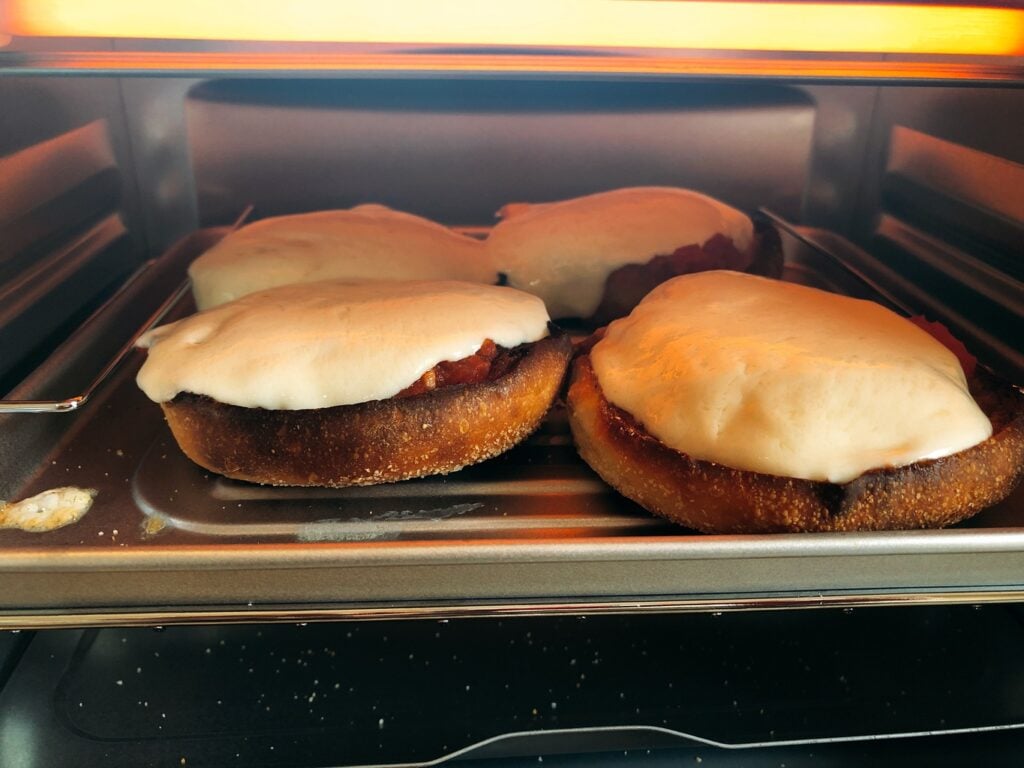 melting mozzarella cheese on Bays English Muffins in a toaster oven