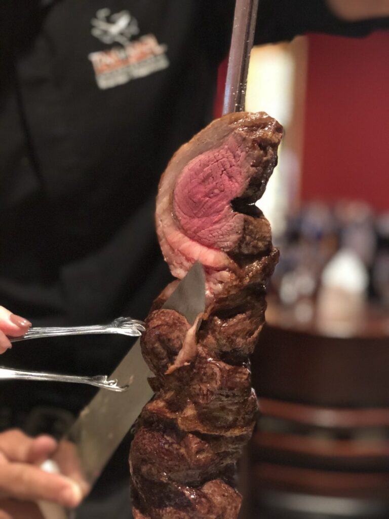 cutting meat at Texas de Brazil Irvine, CA