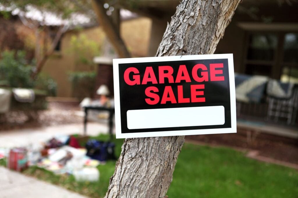 Garage Sale sign posted to a tree