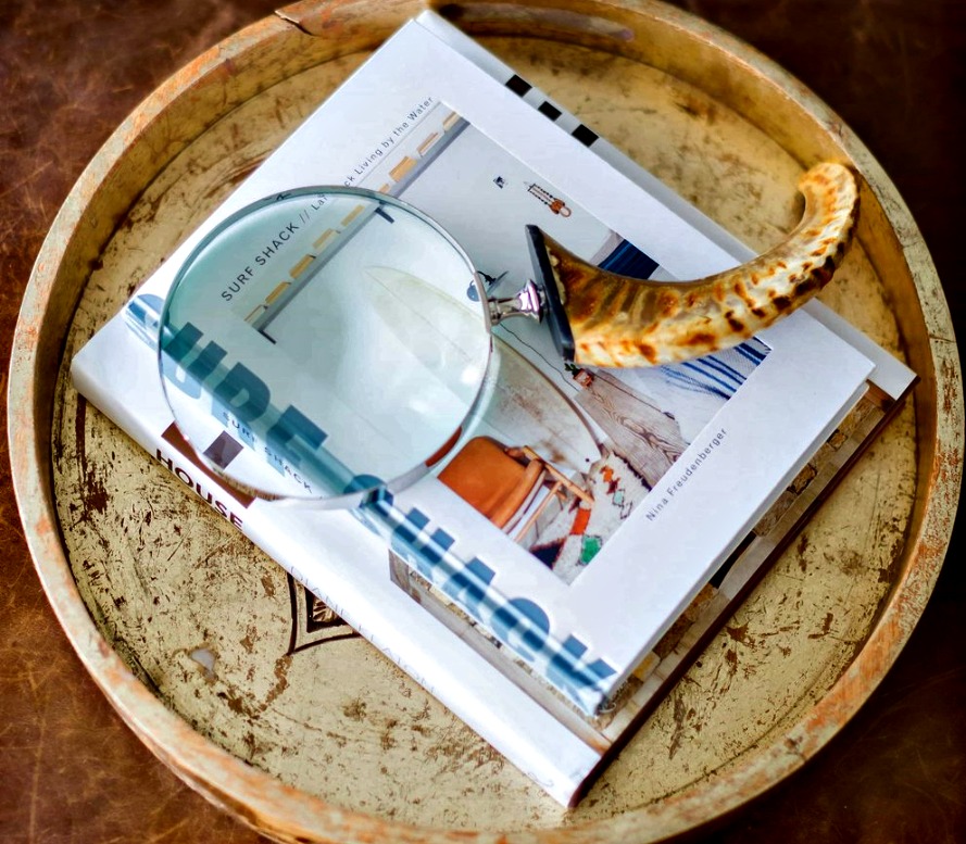 decorative tray with a book and a magnifying glass