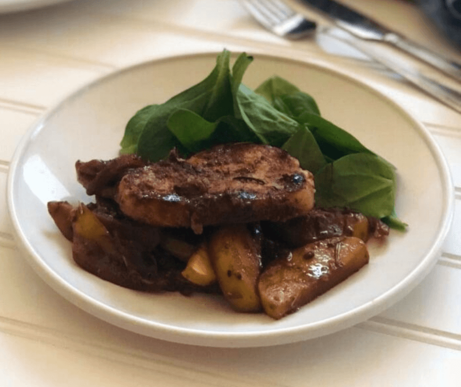 Pan-Fried Boneless Pork Chops on a bed of cooked apple and onions