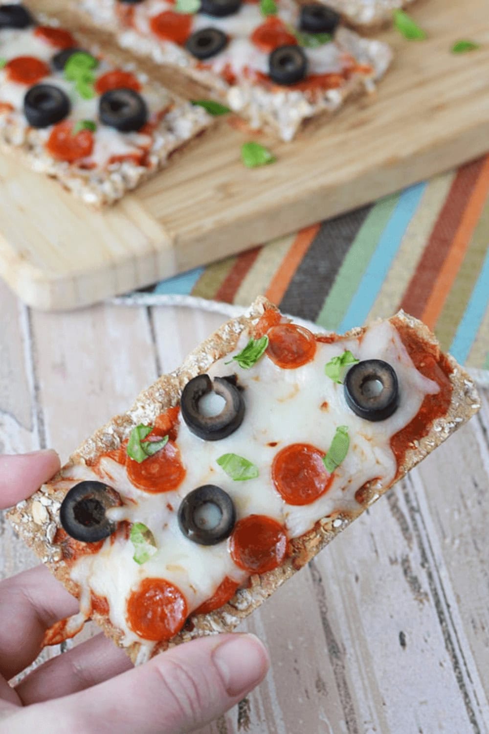 A closeup of WASA Crispbread Pizza Appetizer with a bite