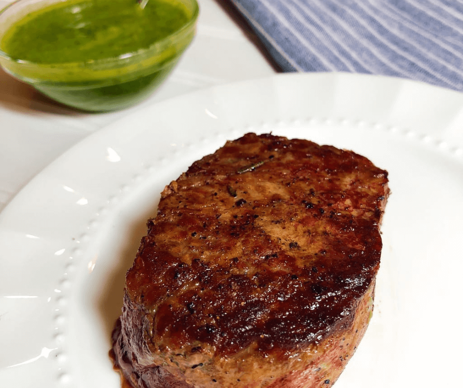 Cooked Omaha Steak on a plate with a homemade Green Goddess Dressing