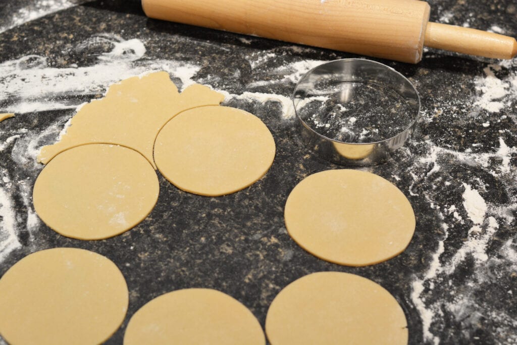 rolling pin rolling out dough for mini apple pies