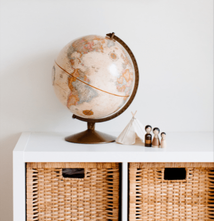 decorative storage photo of wicker baskets inside furniture with a globe on top for decor