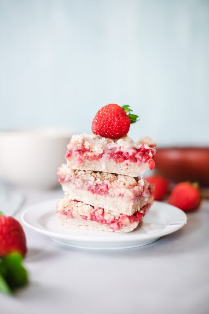Strawberry Banana Breakfast Bars on a plate with a strawberry on top