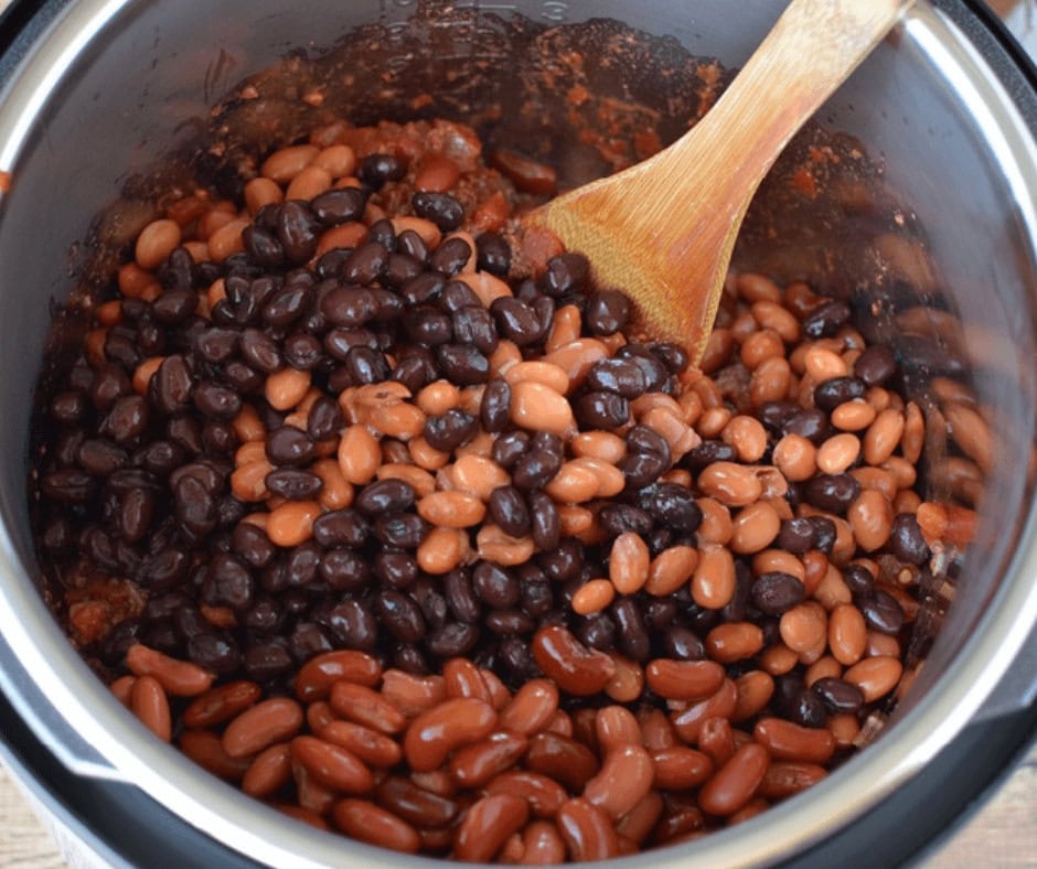 Mixing beans, tomato sauce and water