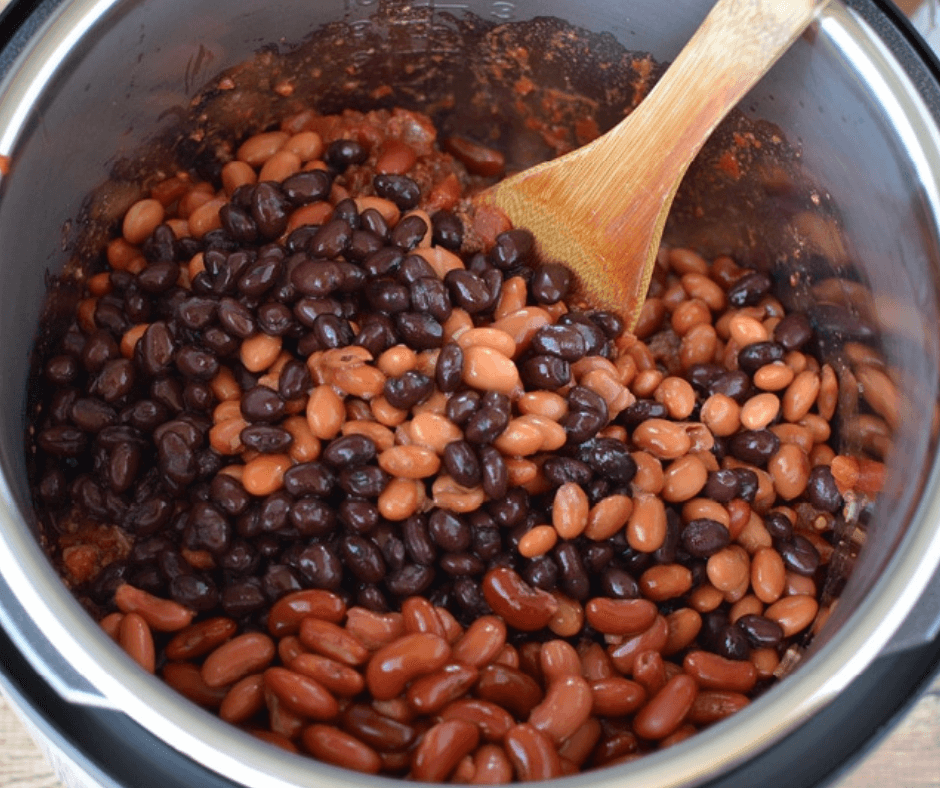 Mixing beans, tomato sauce and water