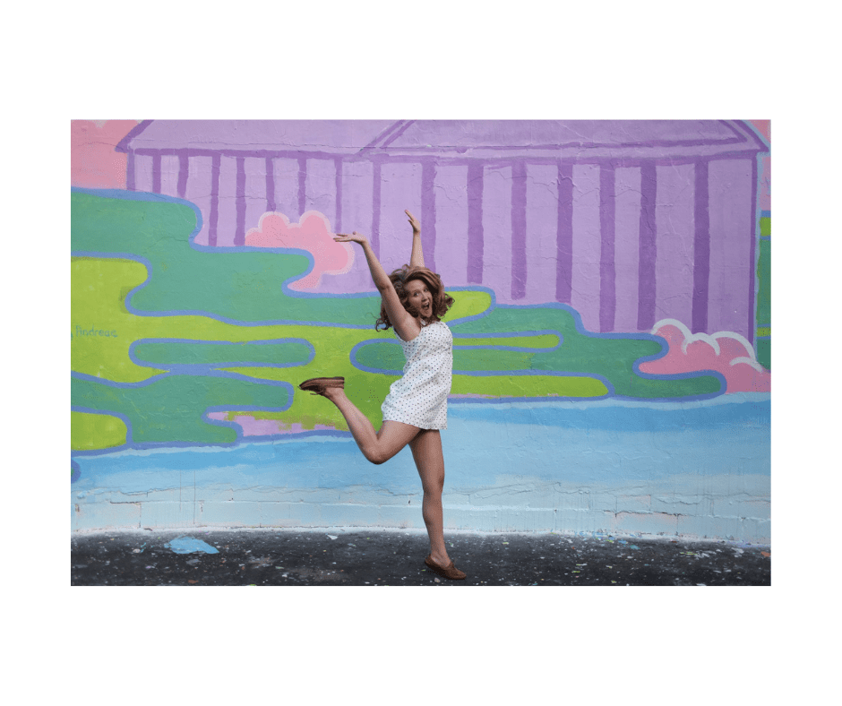 woman jumping for joy with a colorful watercolor background