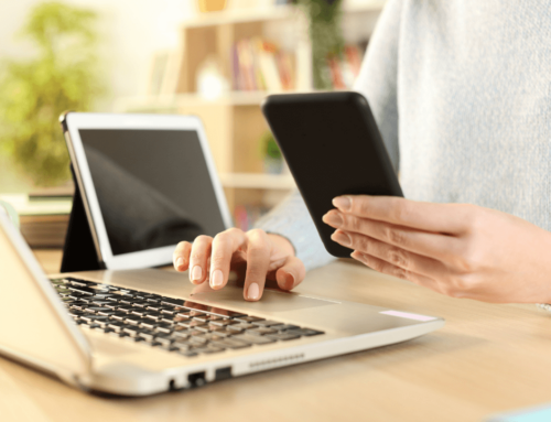 A person using their laptop and phone