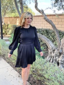 Lori wearing a black Rebecca Taylor Shadow Stripe Dress
