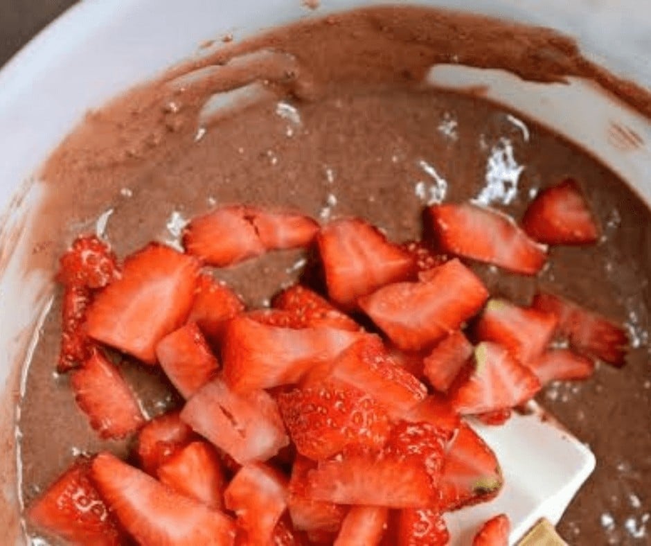 Chocolate muffin batter with strawberries