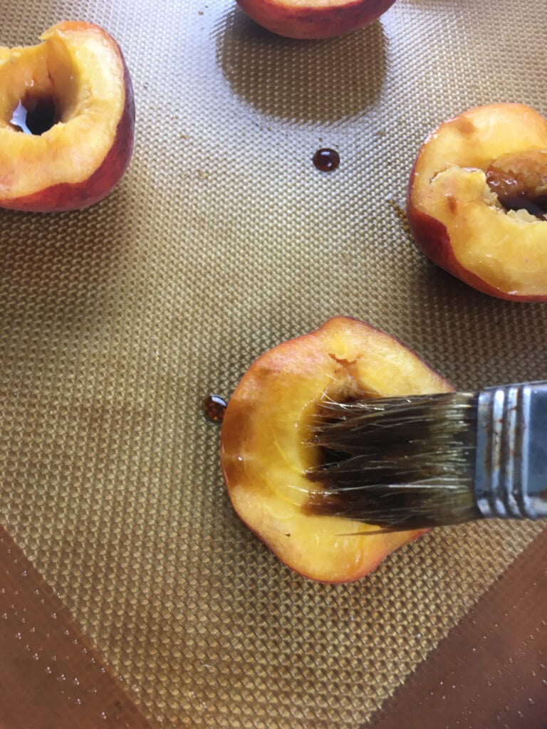 Balsamic Baked Peaches brushing the peaches with pastry brush