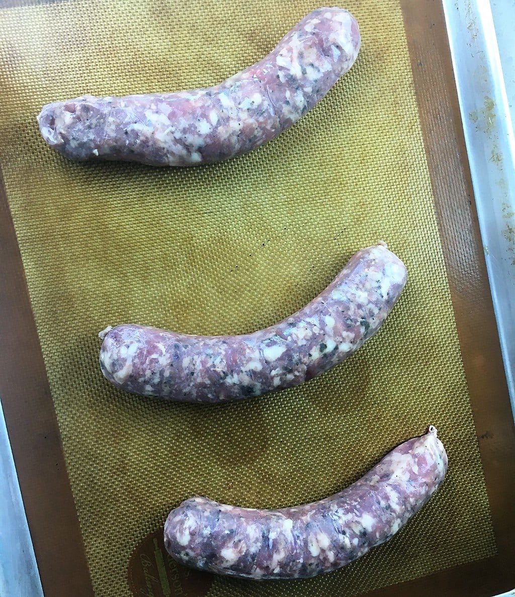 uncooked chorizo links on a Silpat mat