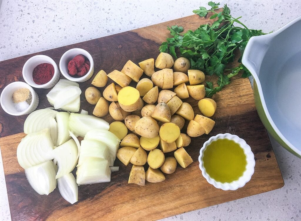 potatoes onions and Spanish paprika on a cutting board