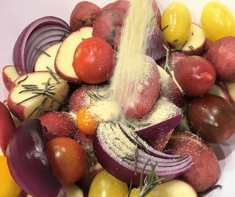 Adding seasoning to the Roasted Potatoes