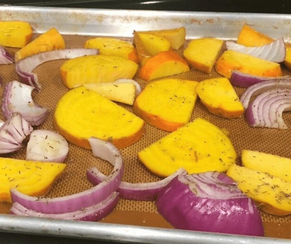 Golden beets and red onions on a sheet pan