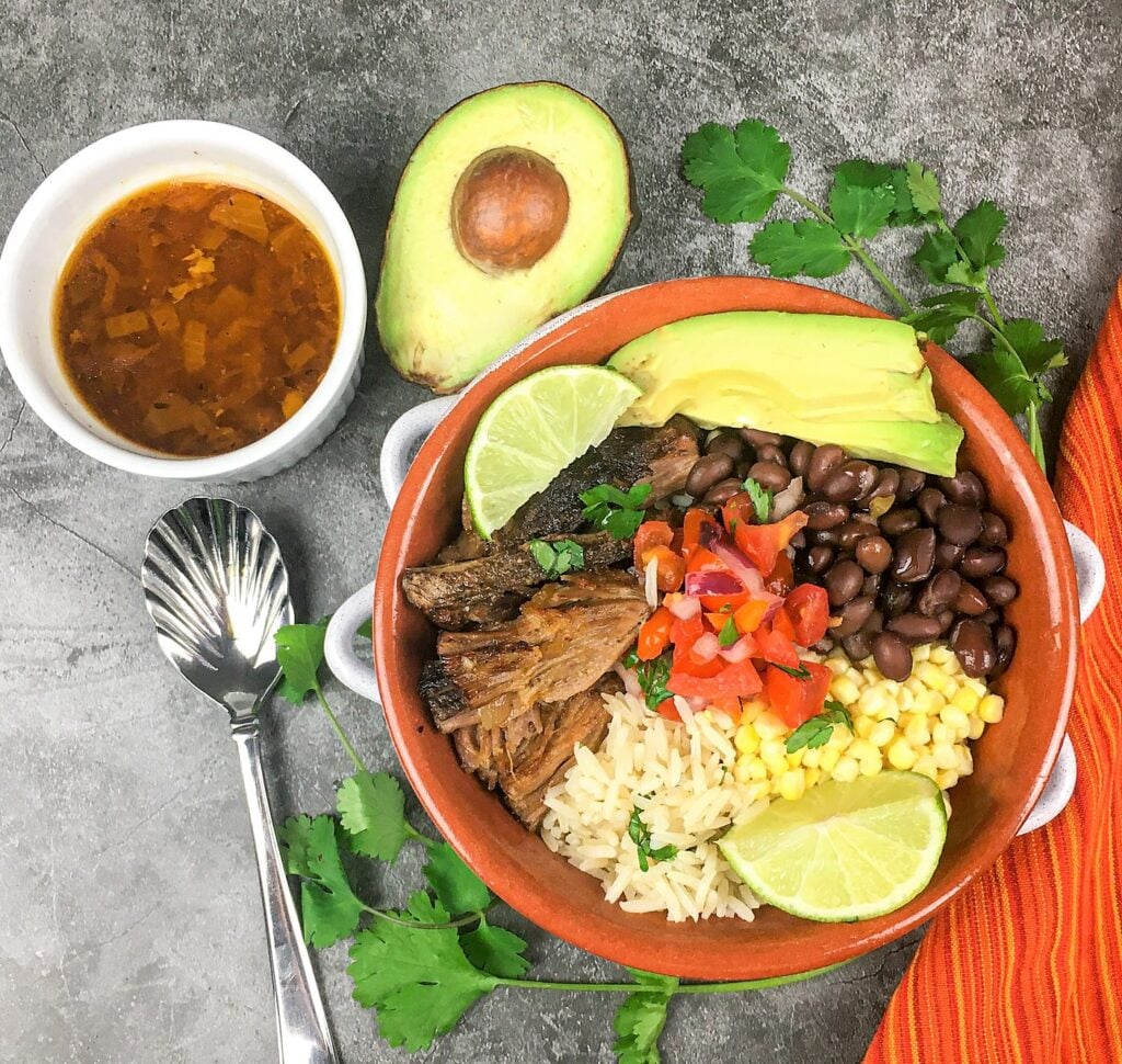 easy pork carnitas bowl served with salsa and avocado