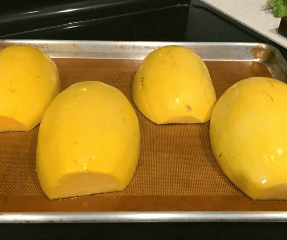 Lining up the slices of Spaghetti Squash on a sheet pan before roasting