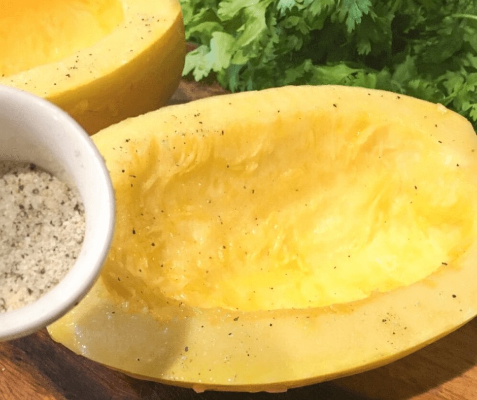 Seasnoning the Spaghetti Squash with salt and pepper