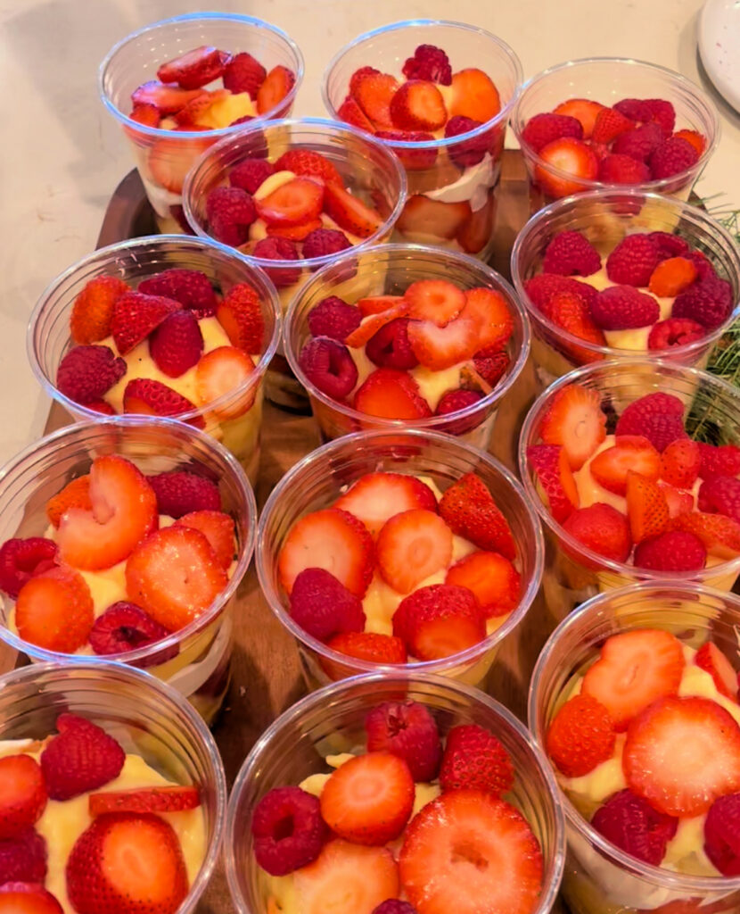 adding a second layer of berries for Individual Trifle Desserts with Pound Cake, Pudding,and Whipped Cream 