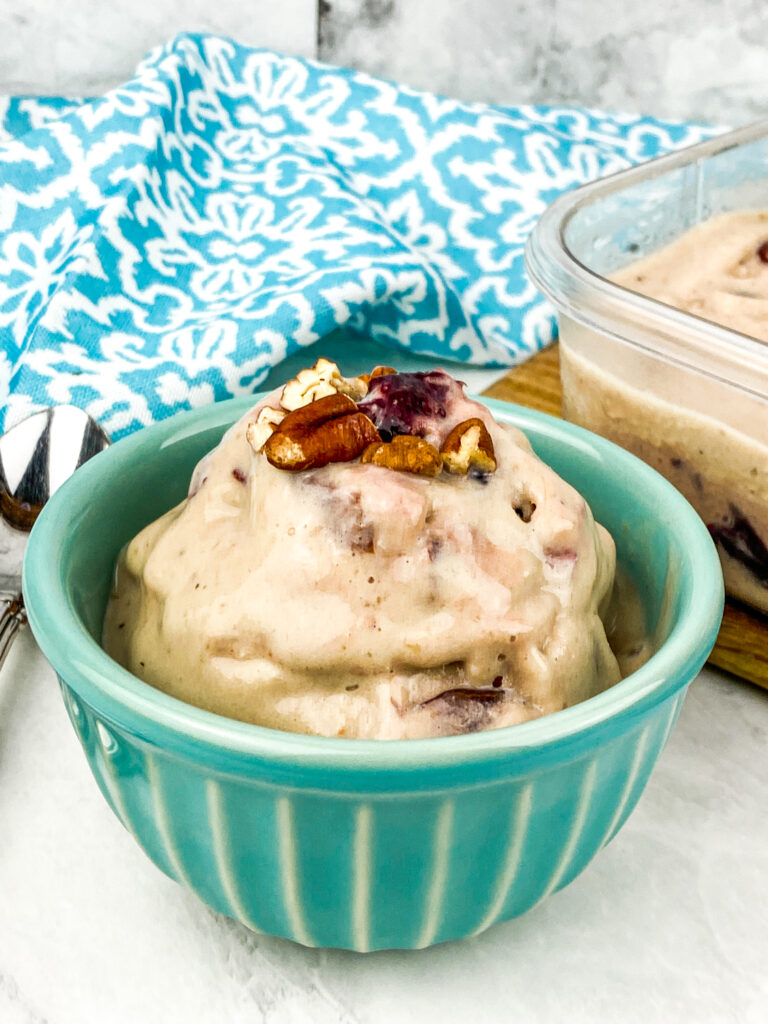 cherry pecan ice cream on a small teal bowl