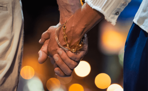 A closeup of a couple's holding hands
