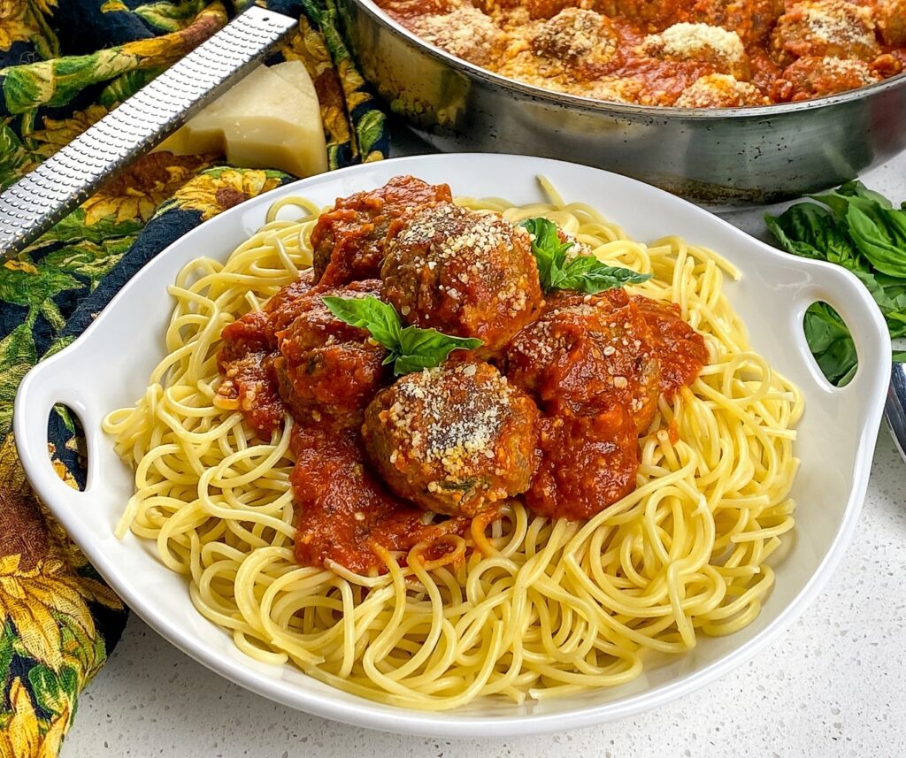 best spaghetti with homemade meatballs on a white serving platter