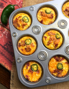 cheesy cauliflower muffins in a muffin tin