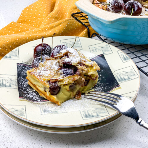 cherry almond clafoutis on a white plate