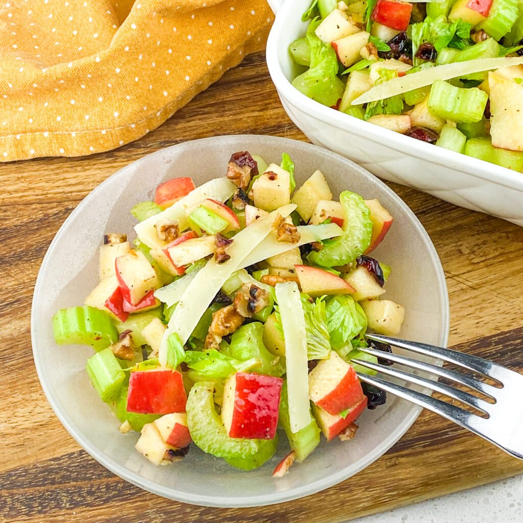 crunchy celery apple salad recipe on a clear salad bowl