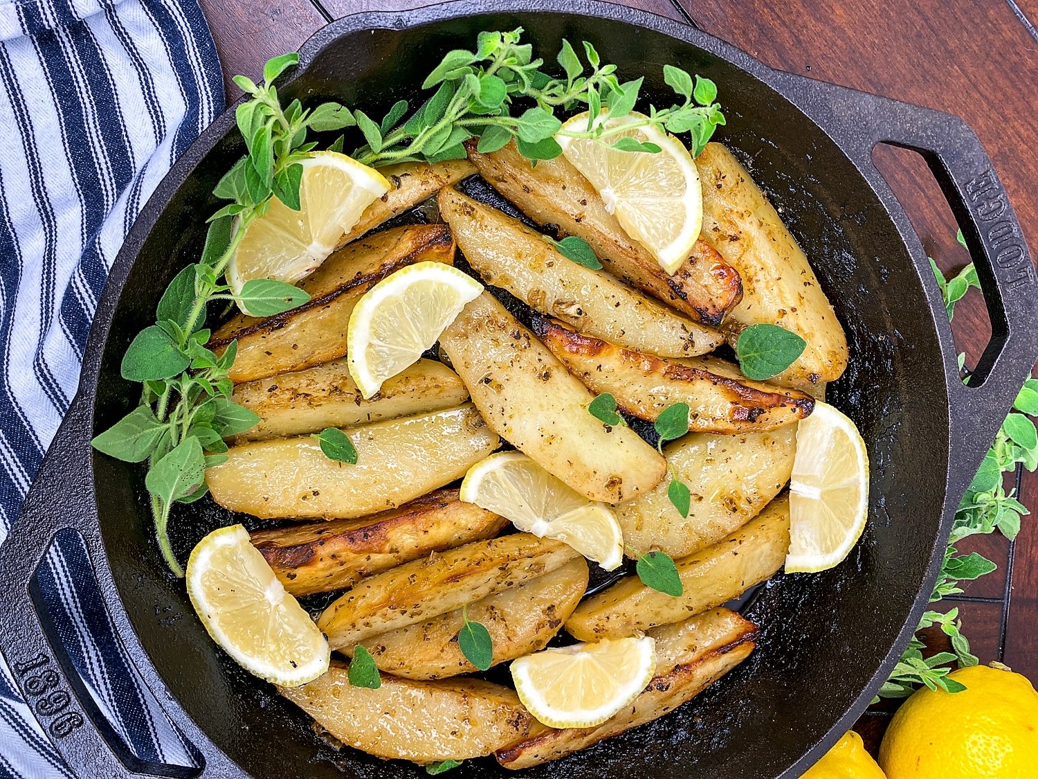 roasted greek-style lemon potatoes on a large skillet