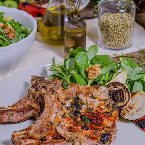 Marinated Grilled Pork Chops on a white plate