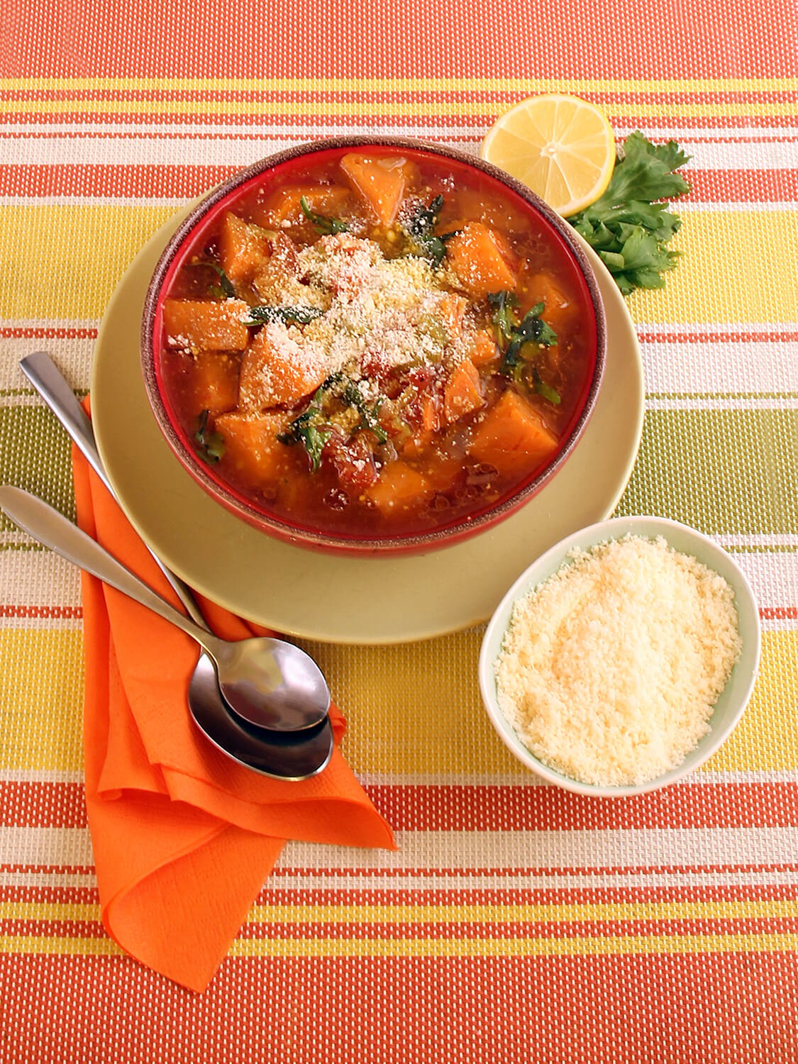 A bowl of Sweet Potato Soup with grated parmesan cheese on the side