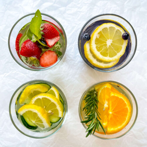close up of 4 glasses of infused water recipes