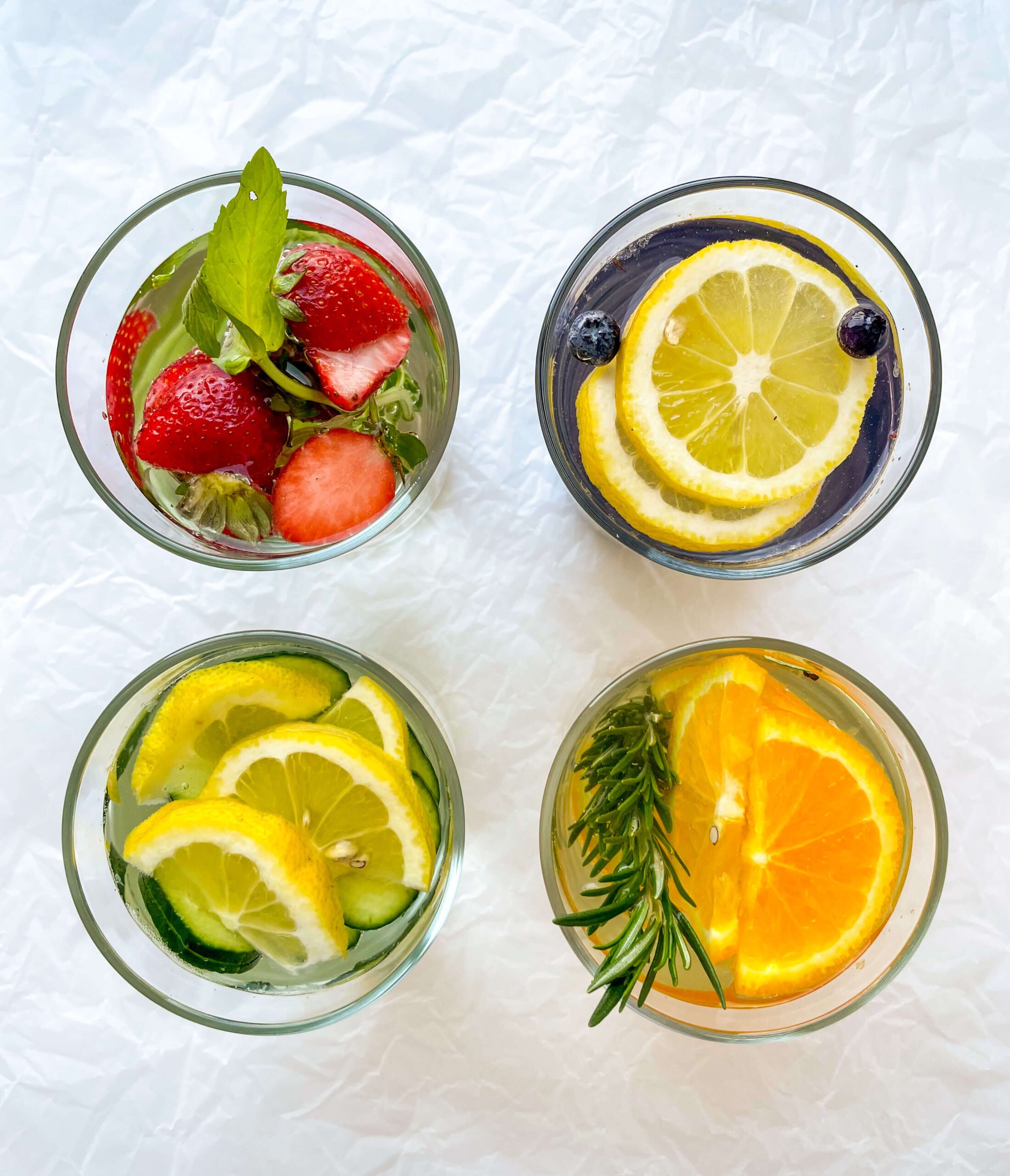 close up of 4 glasses of infused water recipes