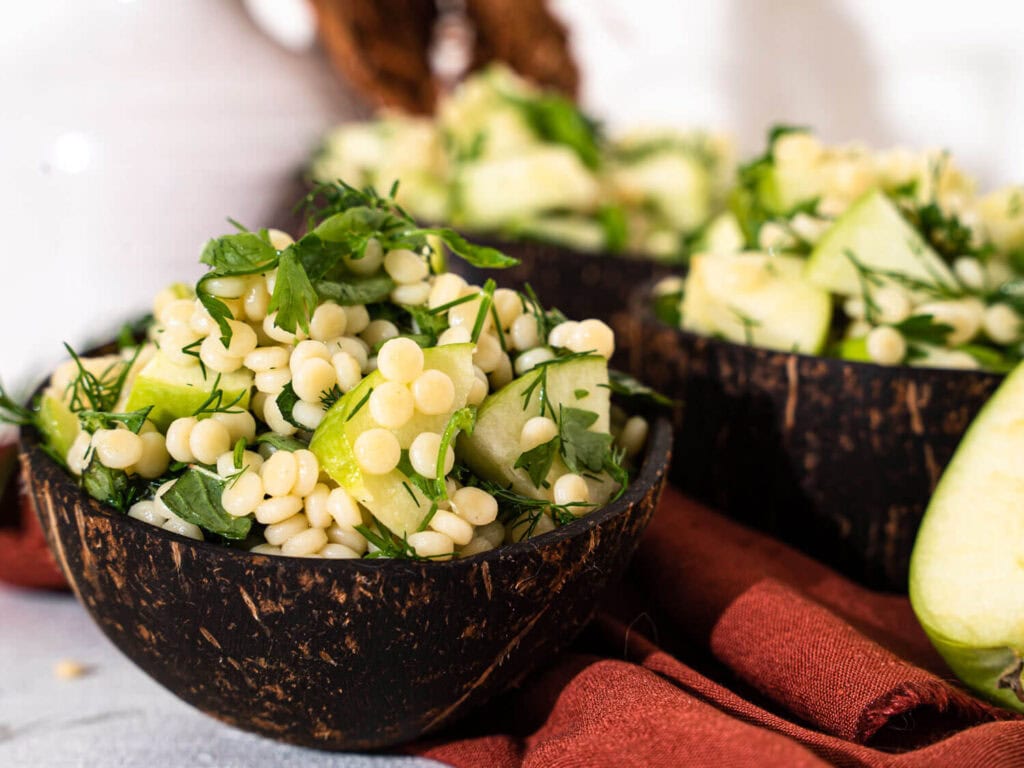 A closeup of a Couscous with Green Apple Salad bowl