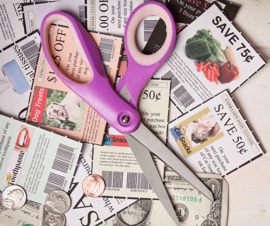 Pair of scissors on top of clipped coupons