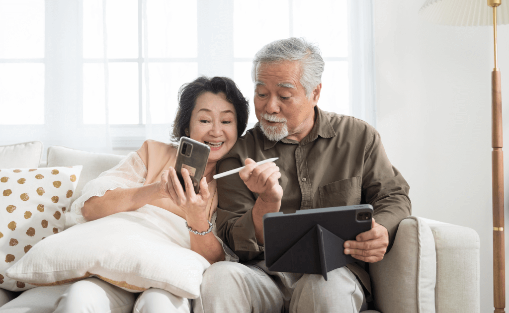 Old couple looking at senior discounts on phones