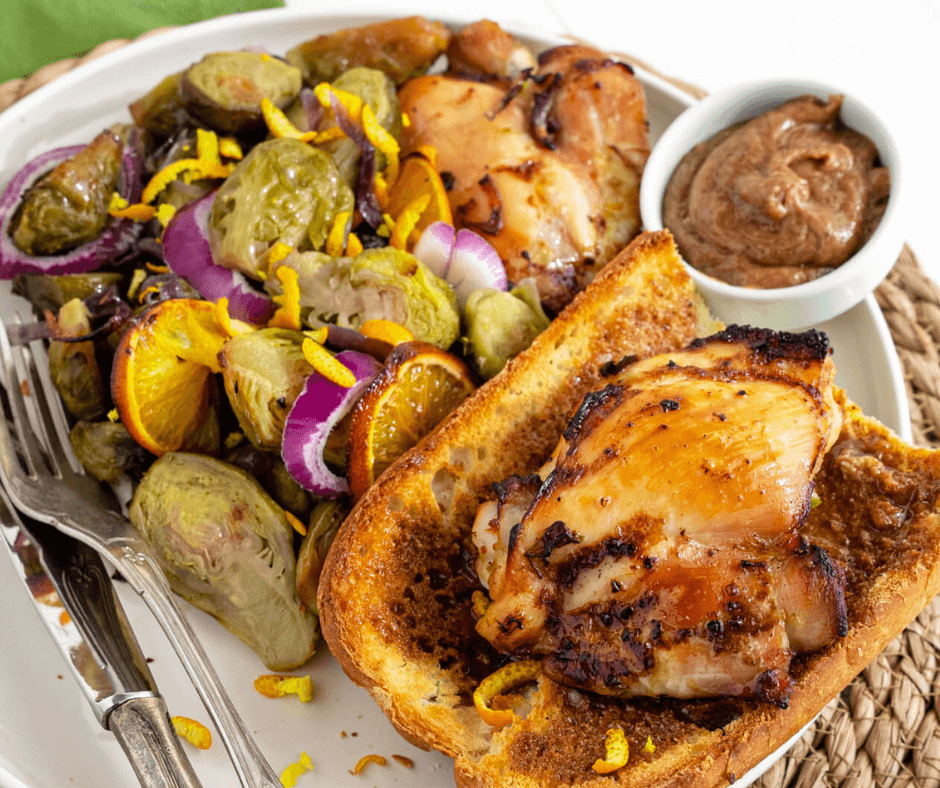 A single serving of Orange Chicken With Brussels Sprouts with Cinnamon Honey Butter on the side