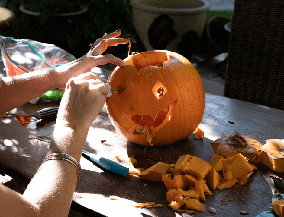 A woman carving a pumpkin - Free Halloween Pumpkin Carving Templates