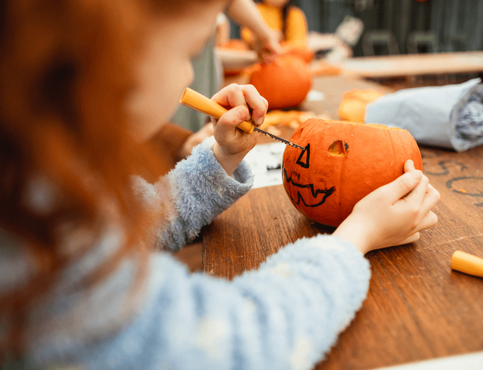 A young girl carving her pumpkin - Free Halloween Pumpkin Carving Templates