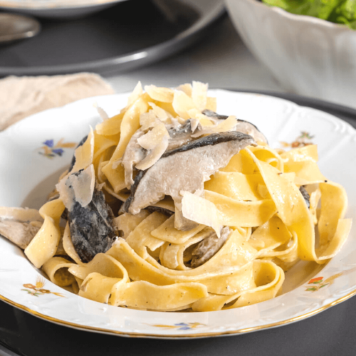 Creamy Mushroom Alfredo Pasta on a white plate