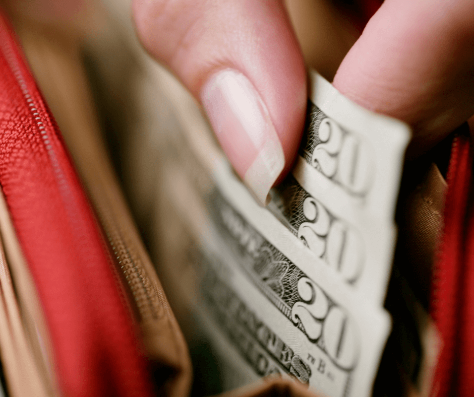 A woman lifting three 20-dollar bills - a photo for New Money-Saving Tips When You Are Feeling the Pinch