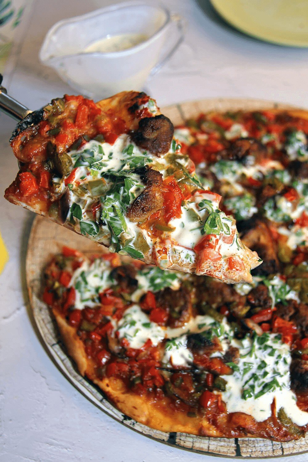 Closeup of a slice of Italian Sausage and Mixed Pepper Pizza