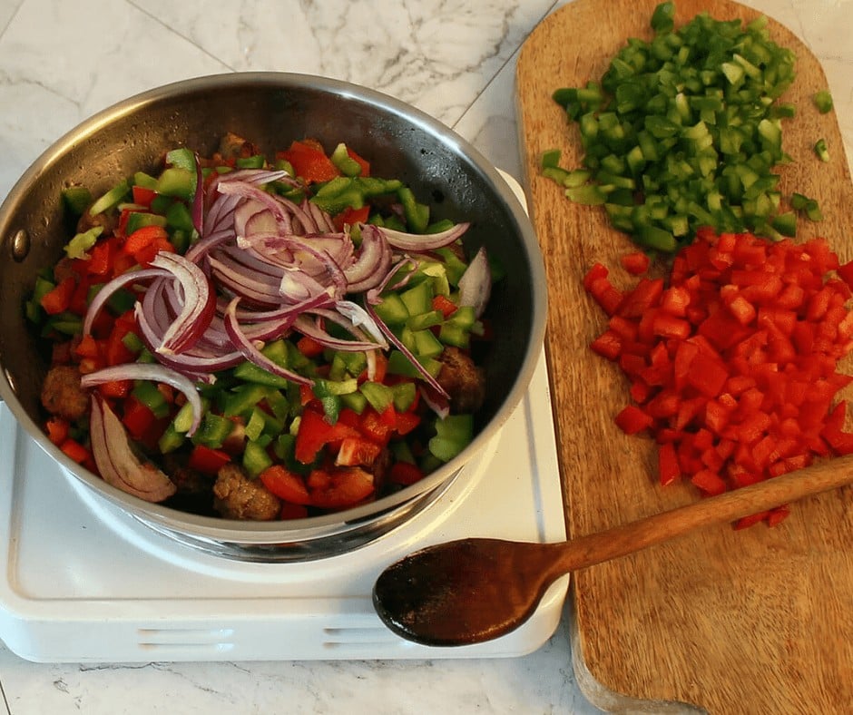 Cooking the bell peppers and onions